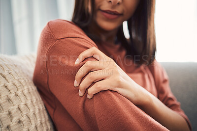 Buy stock photo Woman, hand and pain with shoulder injury on sofa for muscle tension, strain or pressure at home. Closeup, female person or glow with sore joint, cramp or arm ache for accident or sprain at house