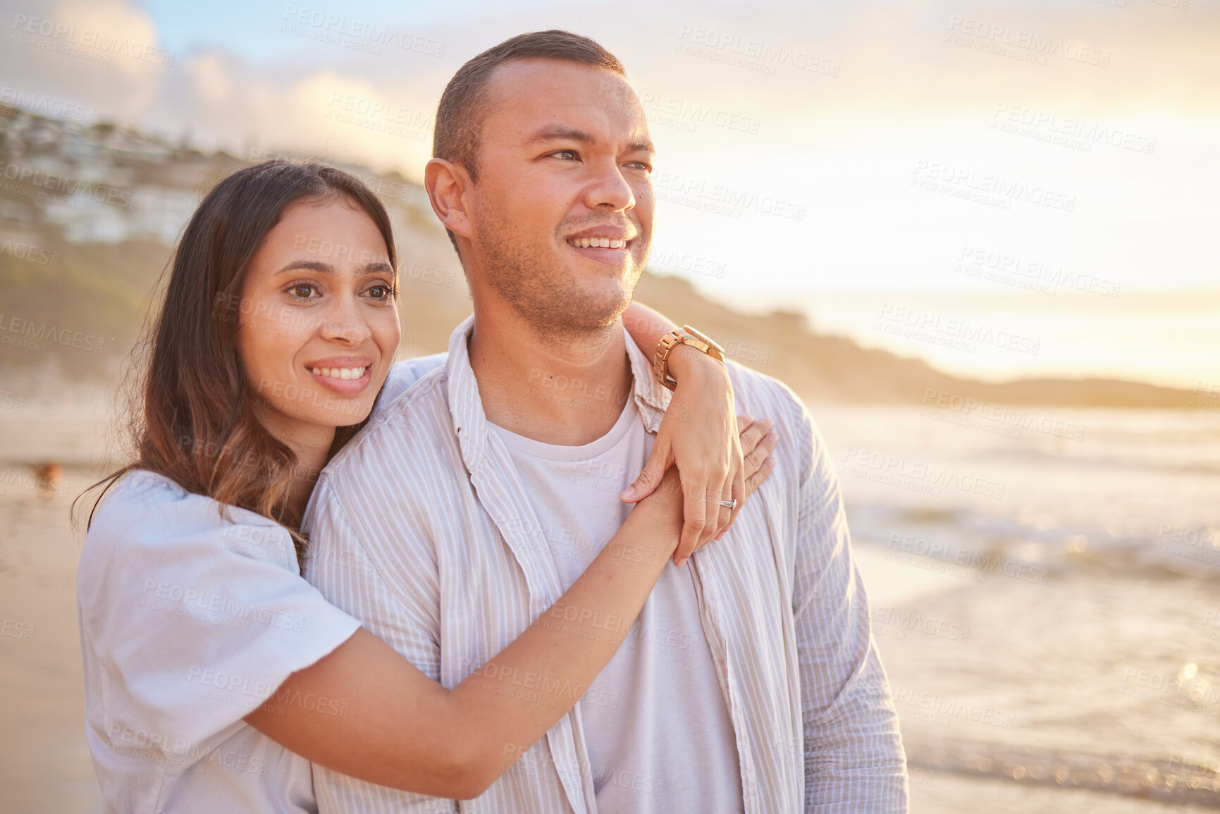 Buy stock photo Happy, couple and hug on beach with love, bonding and romance date for tropical travel in Greece. Smile, woman and man with embrace of relationship, commitment and loyalty for ocean sunset outdoor