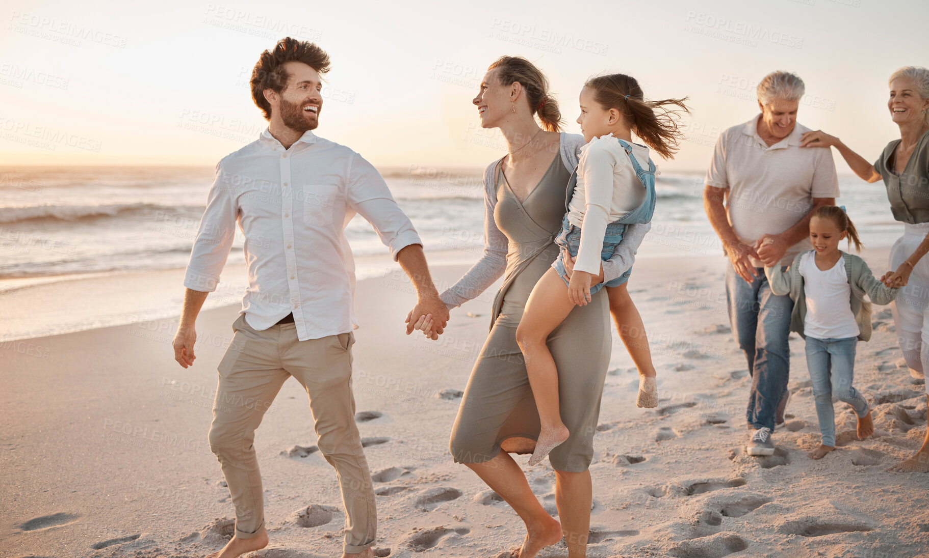 Buy stock photo Parents, grandparents and holding hands with children at beach, sunset or happy with bonding on holiday. Men, women and kids on walk, vacation and outdoor with connection for love with smile in Spain