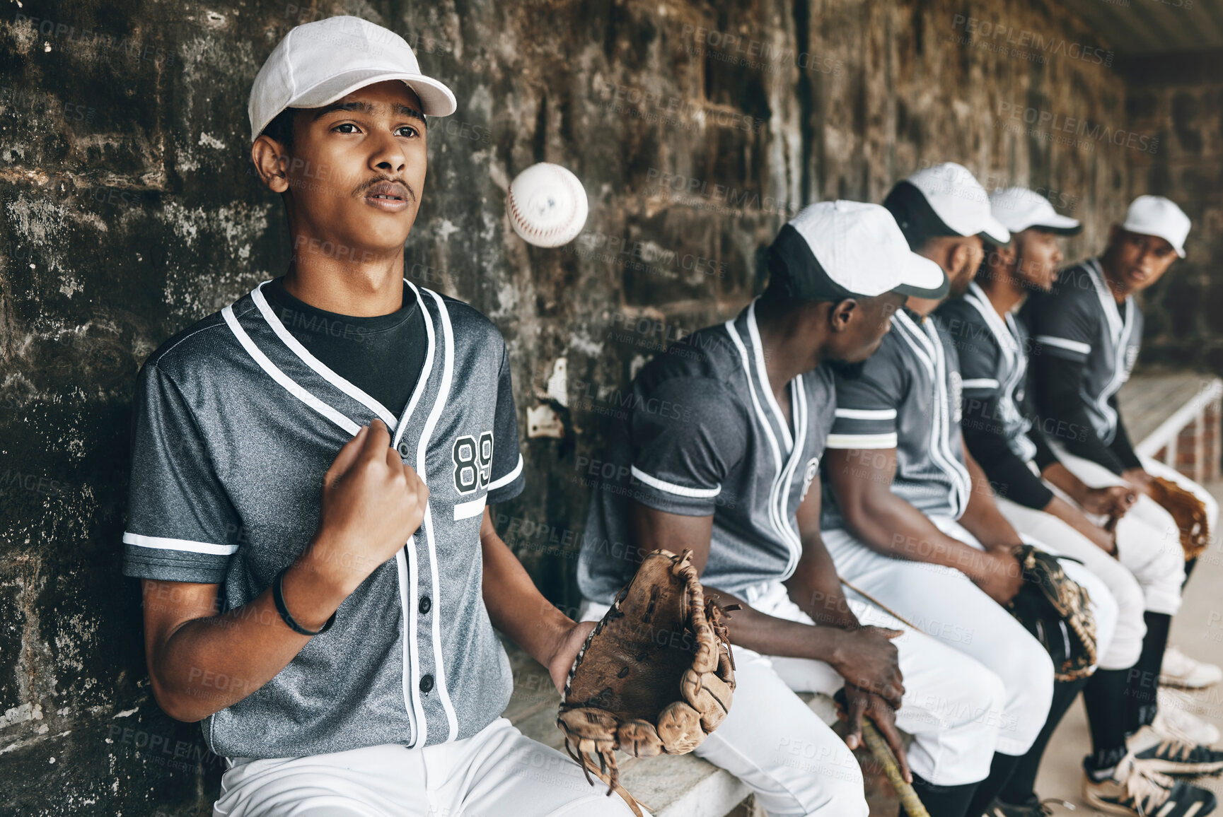 Buy stock photo Baseball, sports and team with a man athlete thinking about the match or game while sitting in the dugout. Exercise, fitness and idea with a male baseball player group ready to play in a match