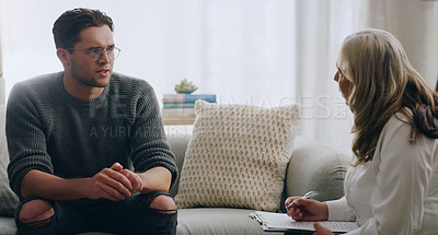 Buy stock photo Therapy, man and therapist talking about mental health during a consultation in an office. Depression, communication and psychologist consulting with sad patient about anxiety or problem of the mind