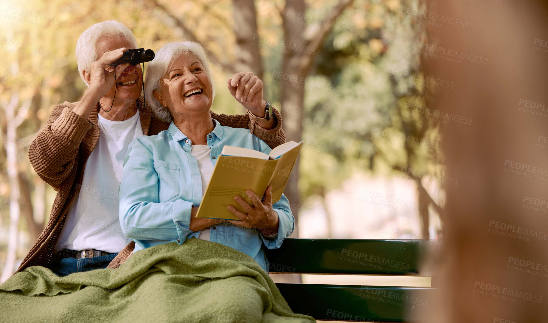 Buy stock photo Love, senior couple and watching birds with book, binocular and romantic together. Romance, mature man and elderly woman in nature, happy and talking about animals, notebook and park bench for hobby.