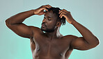 Dreadlocks hair, shirtless man and studio for beauty, self care and cosmetic wellness by blue background. African gen z model, muscle and strong body with hands on head, scalp massage and self love