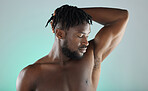 Armpit, wellness and black man with skincare hygiene or grooming isolated against a studio background. Natural, cosmetics and body care for healthy skin by a young, confident and African model