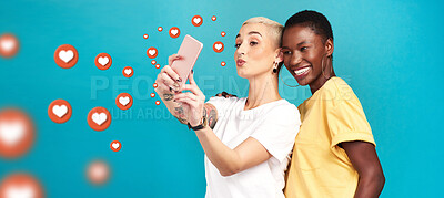 Buy stock photo Diversity, social media icons or women take a selfie for content or online post on blue background. Love emojis, friends or happy girls take fun pictures together on mobile app or network in studio