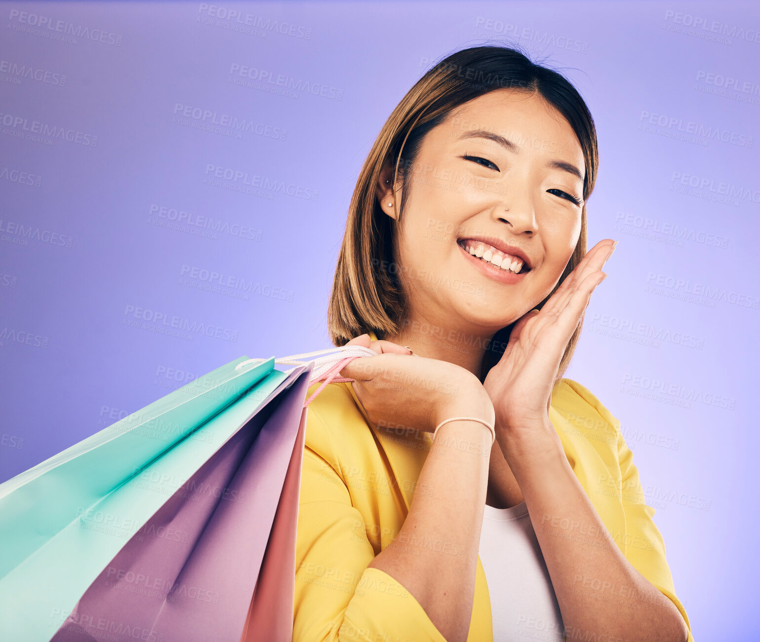 Buy stock photo Smile, portrait and woman with shopping bag, retail and commerce with fashion sale on purple background. Discount at boutique shop, Asian female customer and market with store promotion in studio