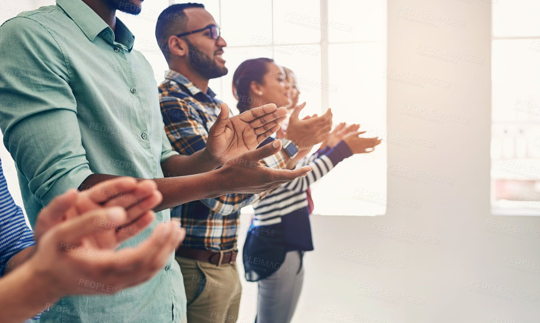 Buy stock photo Cropped shot of a team of designers applauding together in an office