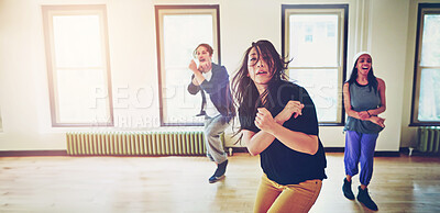 Buy stock photo Shot of a group of young people dancing together in a studio