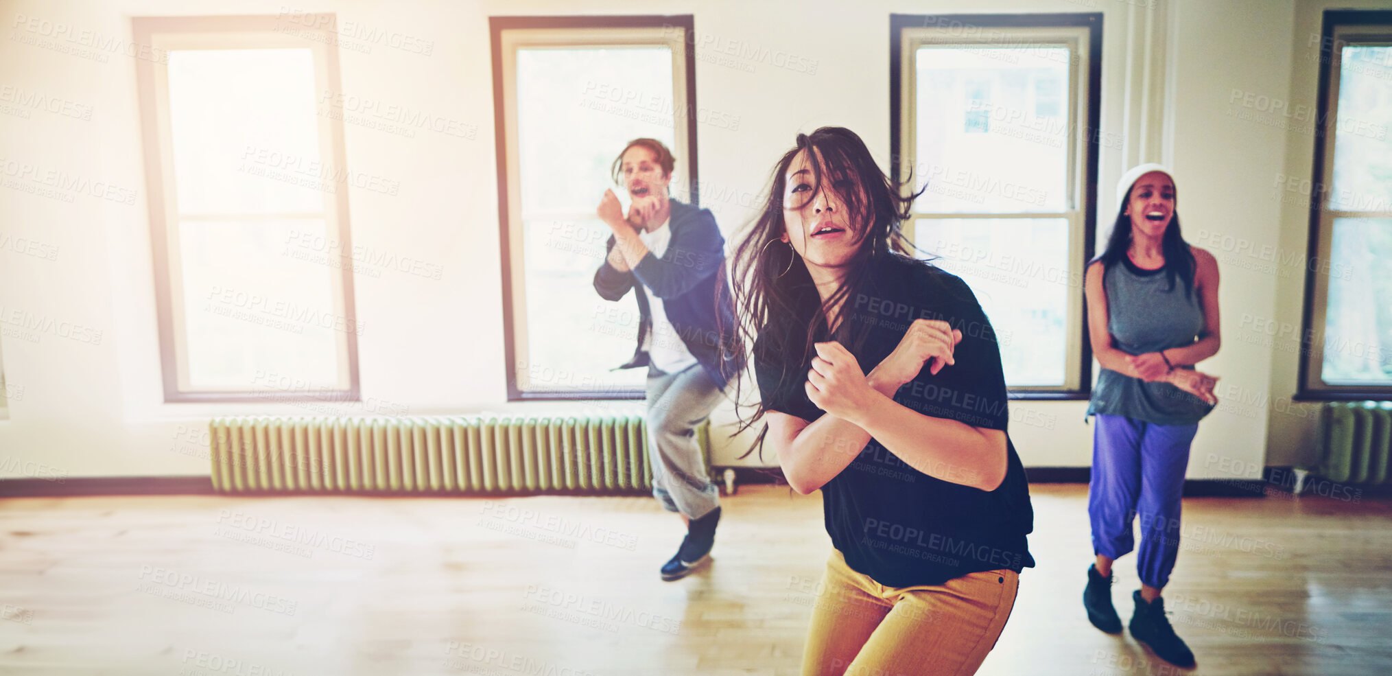 Buy stock photo Shot of a group of young people dancing together in a studio