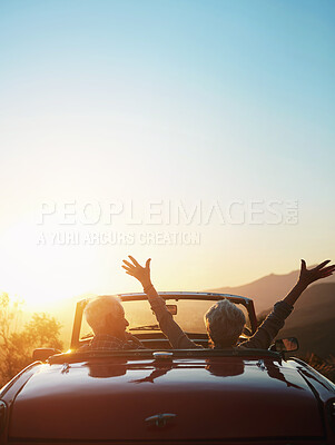 Buy stock photo Shot of a joyful senior couple enjoying the sunset during a roadtrip