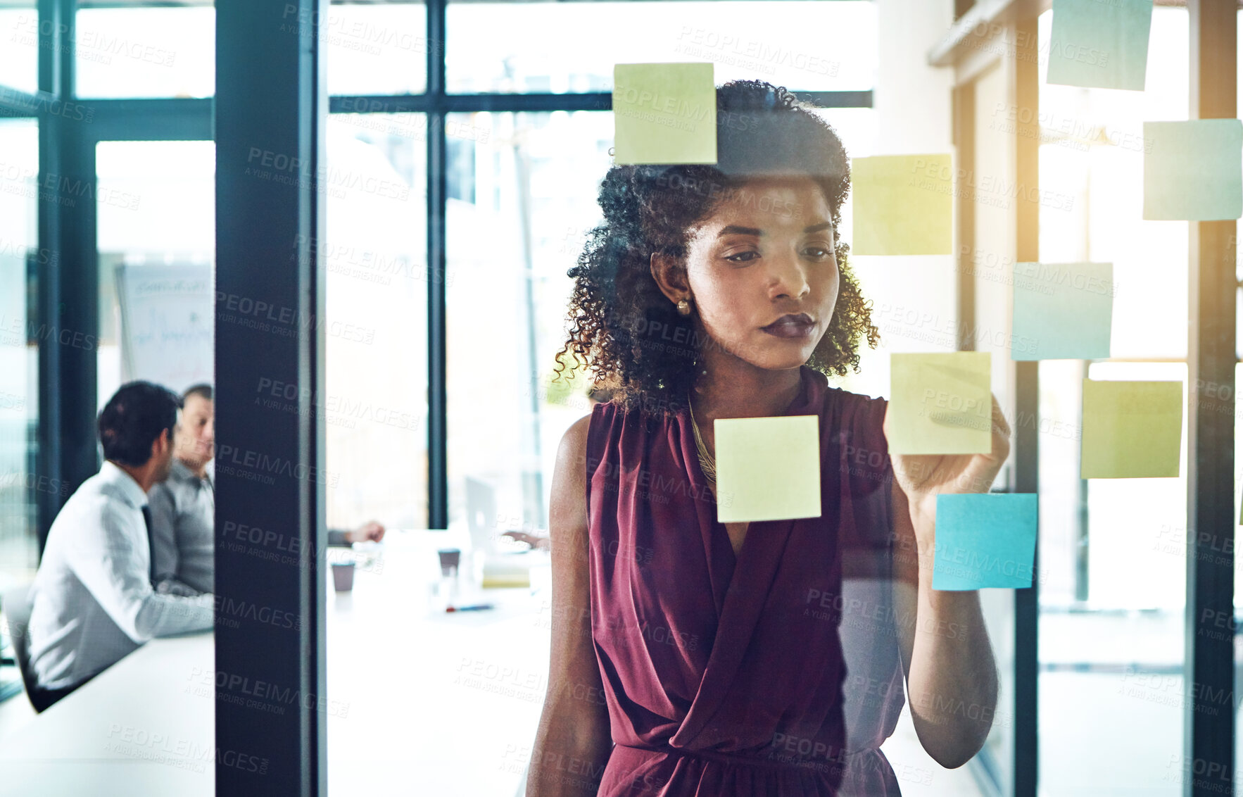 Buy stock photo Shot of a young businesswoman having a brainstorming session at work