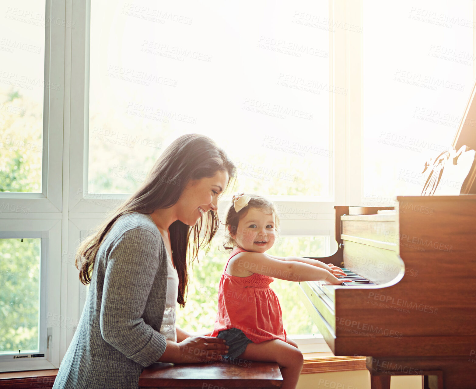 Buy stock photo Playing, music and mother and child with a piano, learning and happy together in a house. Love, smile and portrait of a playful baby with her fun mom teaching to play an instrument for happiness