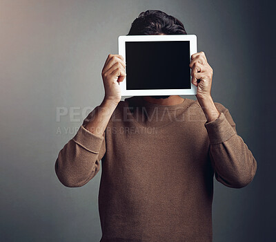 Buy stock photo Tablet screen, space and man covering face in studio isolated on a gray background. Touchscreen, hiding and male person with mockup for marketing, advertising and technology for commercial promotion.