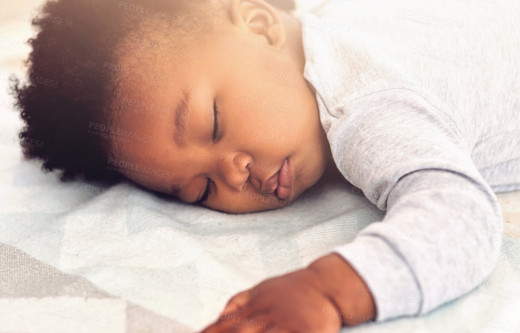 Buy stock photo Baby, african and boy sleeping on bed for rest, health and peace for growth, development and relax in family home. Black male infant, tired and sleep in bedroom with fatigue, quiet and calm in house