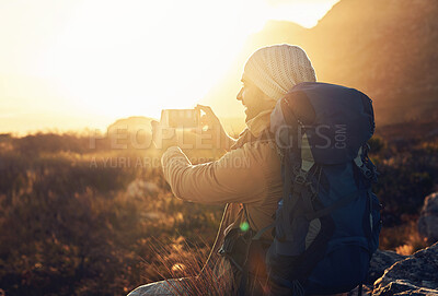 Buy stock photo Flare, hiking and photograph with man in mountains for break, memory or scenic view of nature. Earth, phone camera and rest at sunset with happy person outdoor for adventure, fresh air or journey