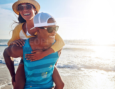 Buy stock photo Couple, piggyback and happy at beach with love, sunglasses and travel for vacation by ocean. Man, woman and back ride on sand in summer with romance, smile and freedom for holiday by water in Greece