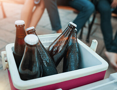 Buy stock photo Friends, drinks and outdoor cooler box for party or celebration and holiday in summer or light leak of sunset. People legs with cold beverage, beer or alcohol bottle in ice for relax hangout at home