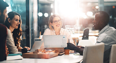 Buy stock photo Teamwork, late night and business people at workshop table with ideas, laptop and pizza at creative agency. Proposal, overtime and diversity, dinner for men and women brainstorming at startup project