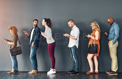 Buy stock photo Studio shot of people waiting in line against a grey background