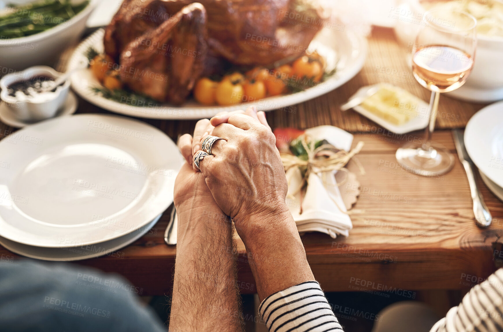 Buy stock photo Hands, pray and food with a senior couple sitting at a dining room table for a roast lunch together. Prayer, grace and holding hands with a mature man and woman eating, bonding or enjoying a meal