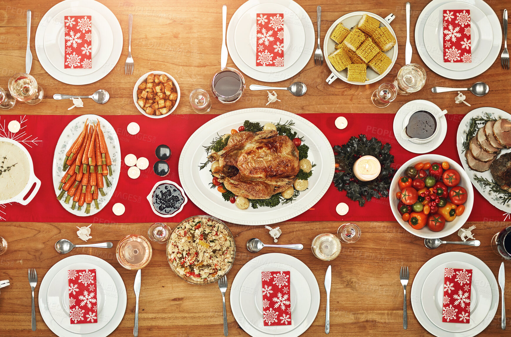 Buy stock photo Christmas, party and food with a festive feast on a dinner table in a home from above for celebration. Chicken, event and nutrition with a meal setting on a wooden surface in the holiday season