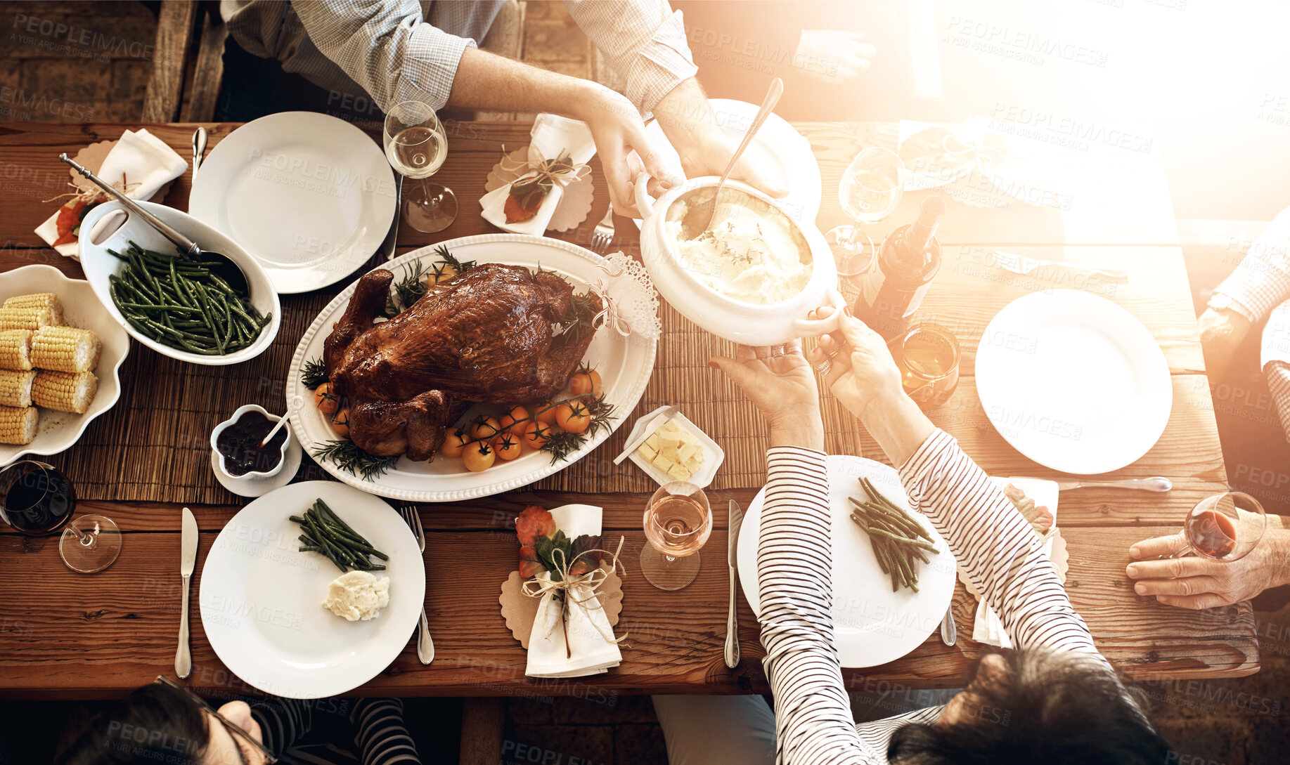 Buy stock photo Food, people and eating together at table for holiday celebration or dinner party. Above group of family or friends hands sharing healthy lunch with chicken or turkey, vegetables and wine drinks