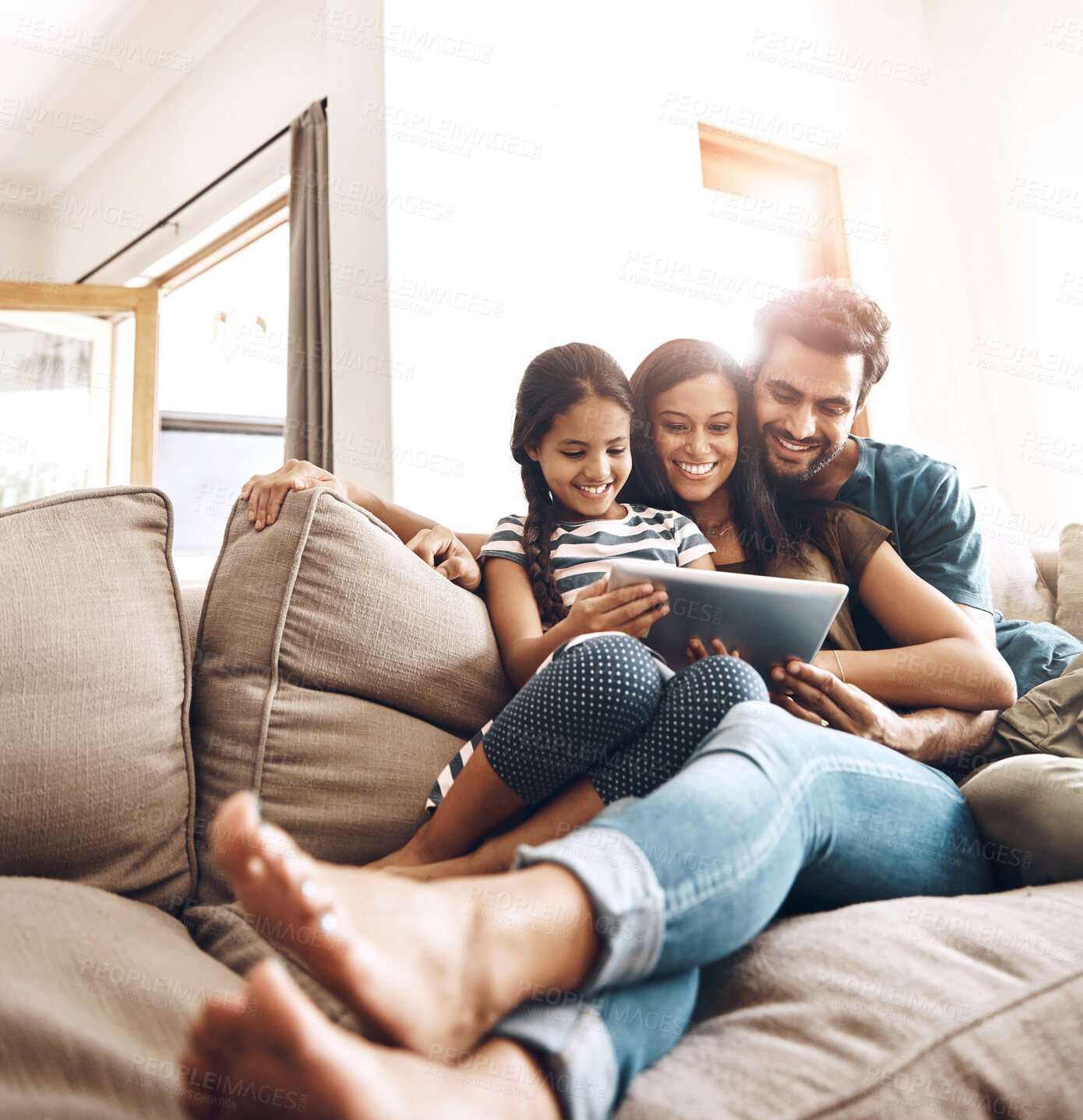 Buy stock photo Love, smile and family on a couch, tablet and happiness at home, relax and connection for social media. Parents, happy mother and father on a sofa, technology and online reading with a female child