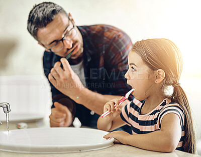 Buy stock photo Child, father and brushing teeth in bathroom, bonding and cleaning together. Dad, girl and toothbrush for dental hygiene, oral wellness or healthy tooth for family care, teaching and learning in home