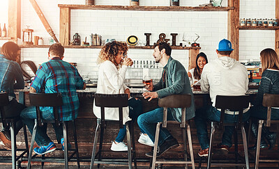 Buy stock photo Shot of young people enjoying a drink at a bar