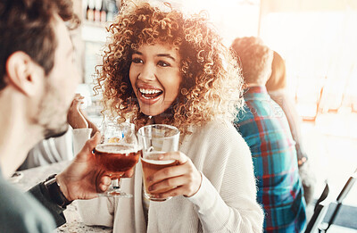 Buy stock photo Shot of a young couple enjoying a drink at a bar