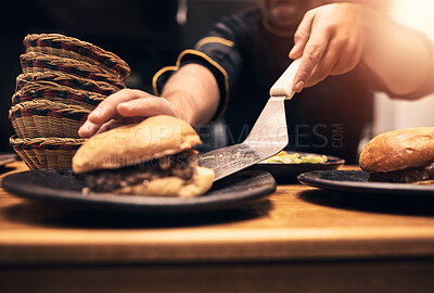 Buy stock photo Chef, person and hands in kitchen with burger, fast food and preparation on table. Male cook, meal and dinner of sandwich, order and culinary for hospitality service with cooking for professional