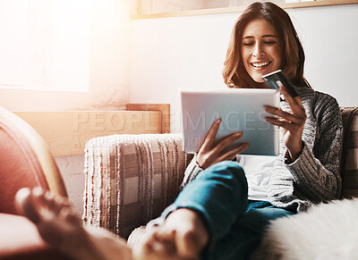 Buy stock photo Relax, tablet and credit card with an ecommerce woman sitting on a sofa in the living room of her home. Online shopping, fintech and financial banking with a young female online customer in her house