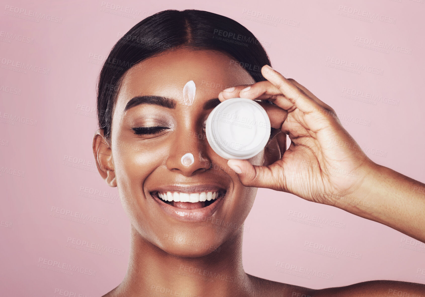 Buy stock photo Smile, skincare and woman with cream container in studio isolated on pink background mockup space. Eyes closed, creme cosmetics and Indian female model with lotion, moisturizer product or dermatology