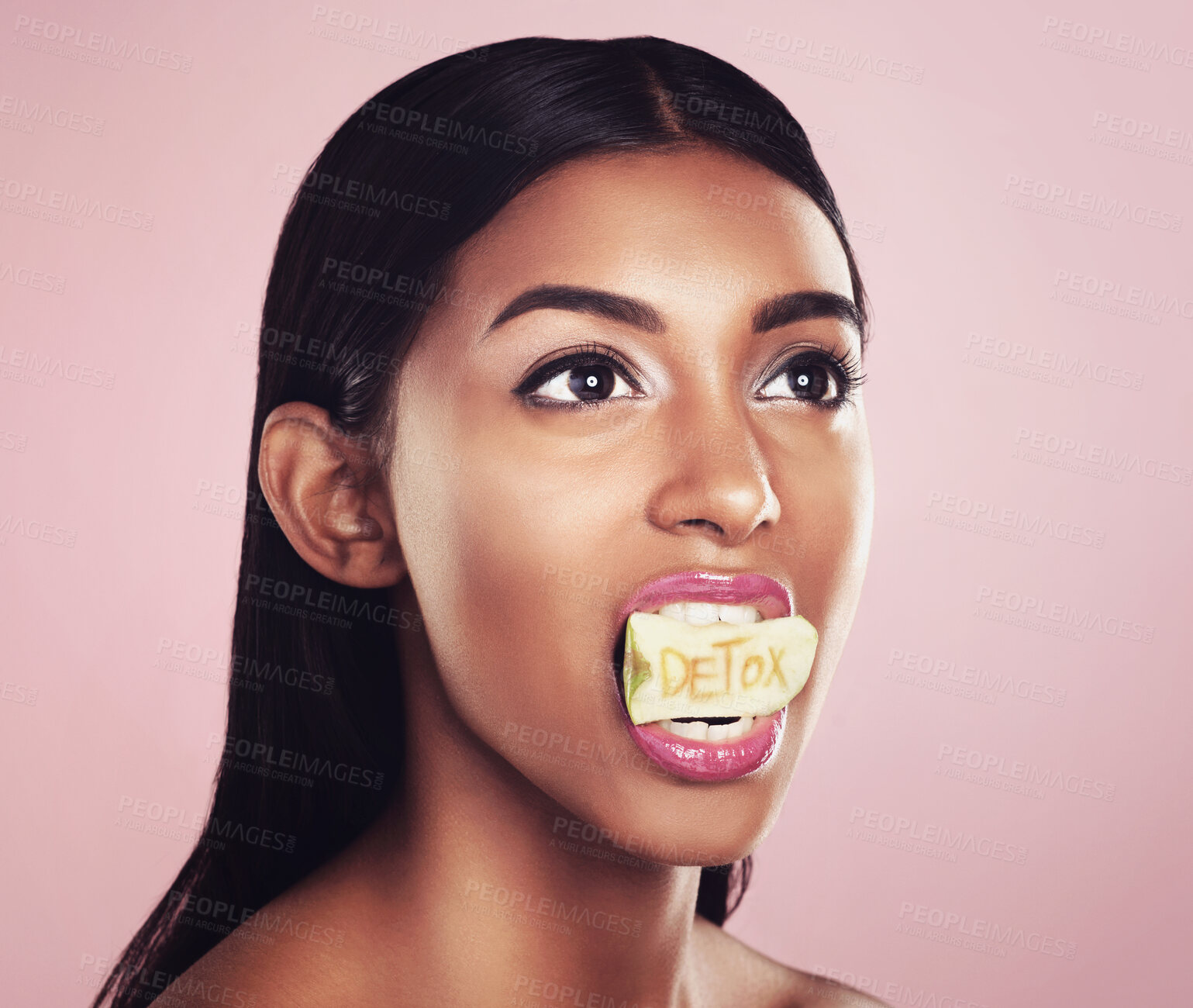 Buy stock photo Detox, fruit and woman with apple in her mouth for beauty empowerment isolated in a studio pink background. Skincare, food and female model or person on diet for self love or cosmetic care