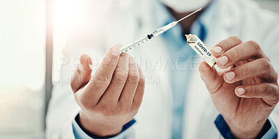 Buy stock photo Shot of a scientist extracting medication using a syringe from an ampoule with 2019-nCov on it