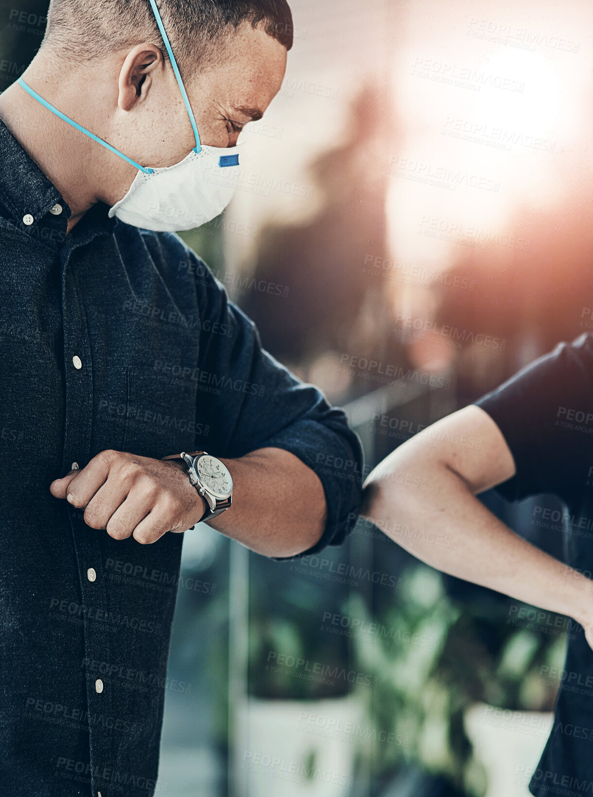 Buy stock photo Shot of a young man bumping elbows with an unrecognisable woman outdoors