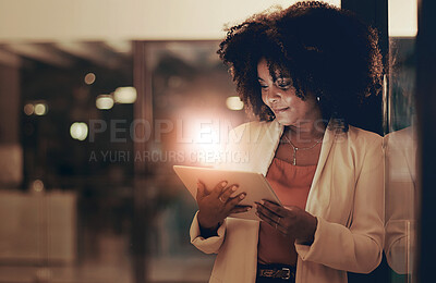 Buy stock photo Shot of a businesswoman using a digital tablet in an office at night