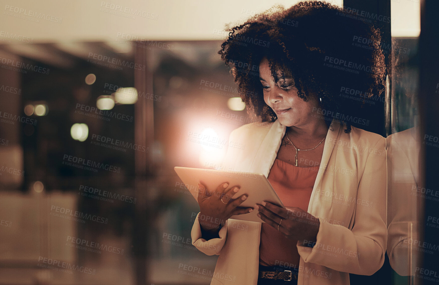 Buy stock photo Shot of a businesswoman using a digital tablet in an office at night