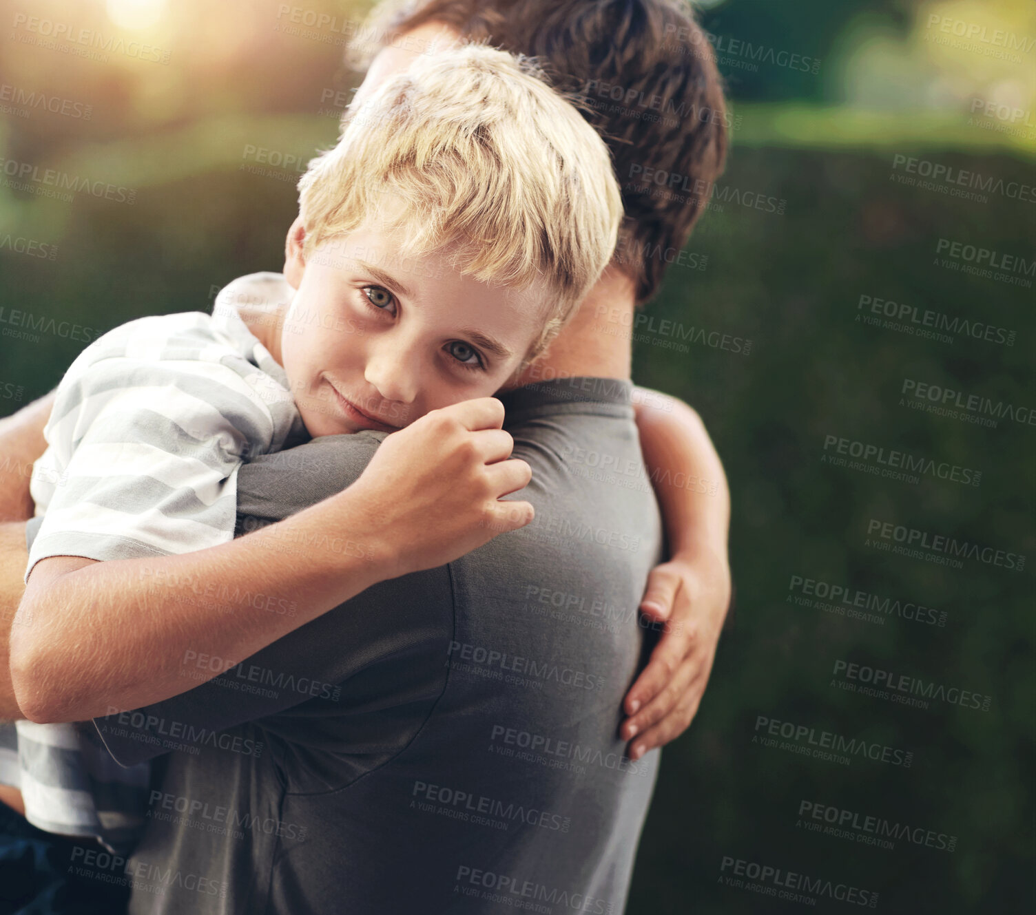 Buy stock photo Portrait of dad hugging kid in backyard, support and bonding together in comfort, care and love. Smile, father and face of child in garden with happy relationship, trust for man and boy or family