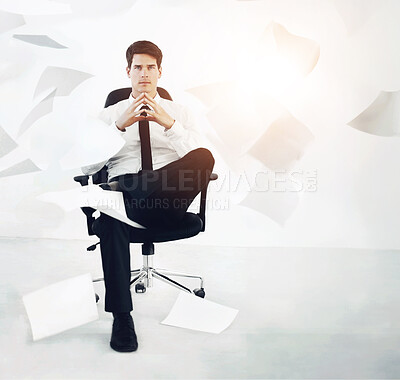 Buy stock photo Confident businessman sitting in a chair with sheets of paper falling around him - Business concept