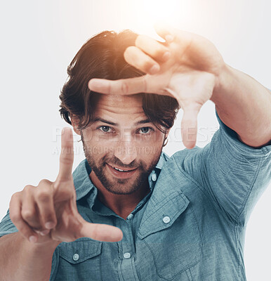 Buy stock photo Frame, hands and portrait of man on a white background for vision, innovation and photography isolated in studio. Fashion, creative and face of male model with hands sign for focus or perspective