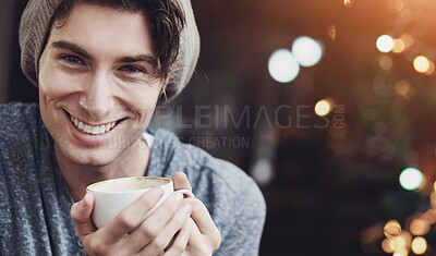 Buy stock photo A young male smiling as he holds his coffee