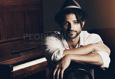 Buy stock photo Portrait of a young musician sitting in front of his piano