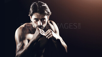 Buy stock photo Portrait of a muscular young boxer standing ready to fight