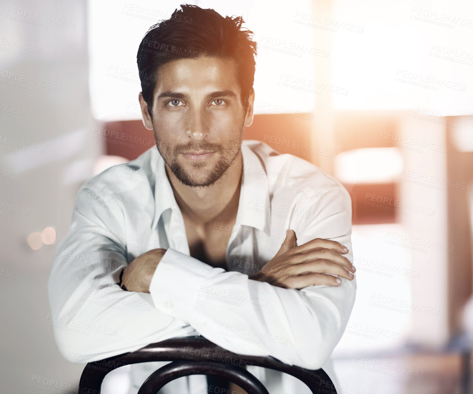 Buy stock photo A handsome young man wearing sunglasses and sitting on a chair