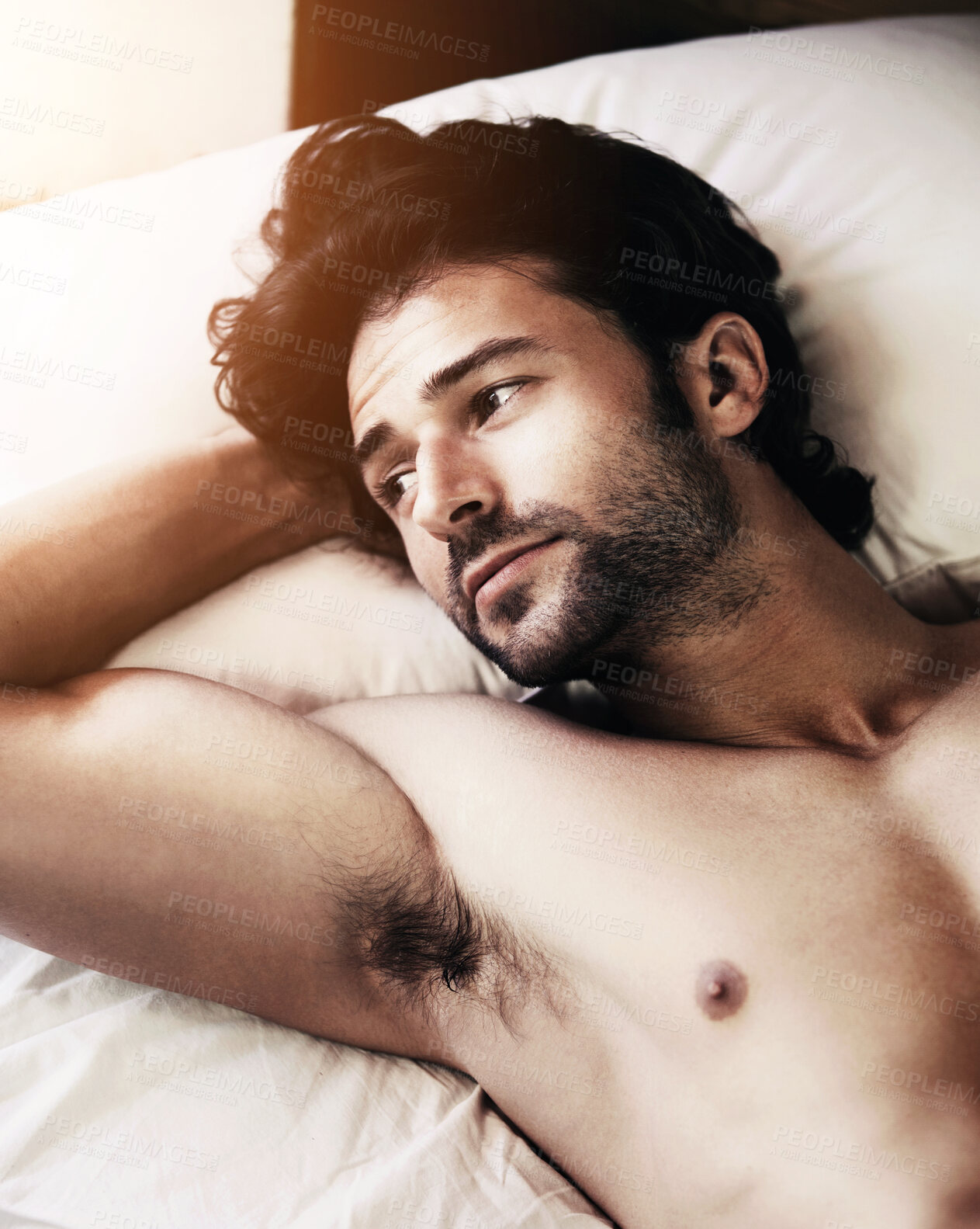 Buy stock photo Handsome young man lying awake and thinking while in bed