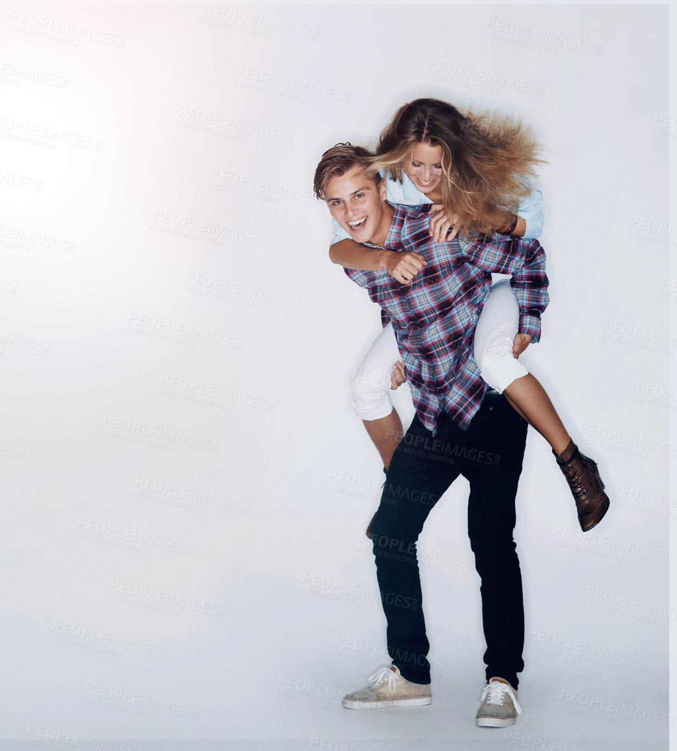 Buy stock photo Portrait of a male hipster giving a female hipster a piggyback ride