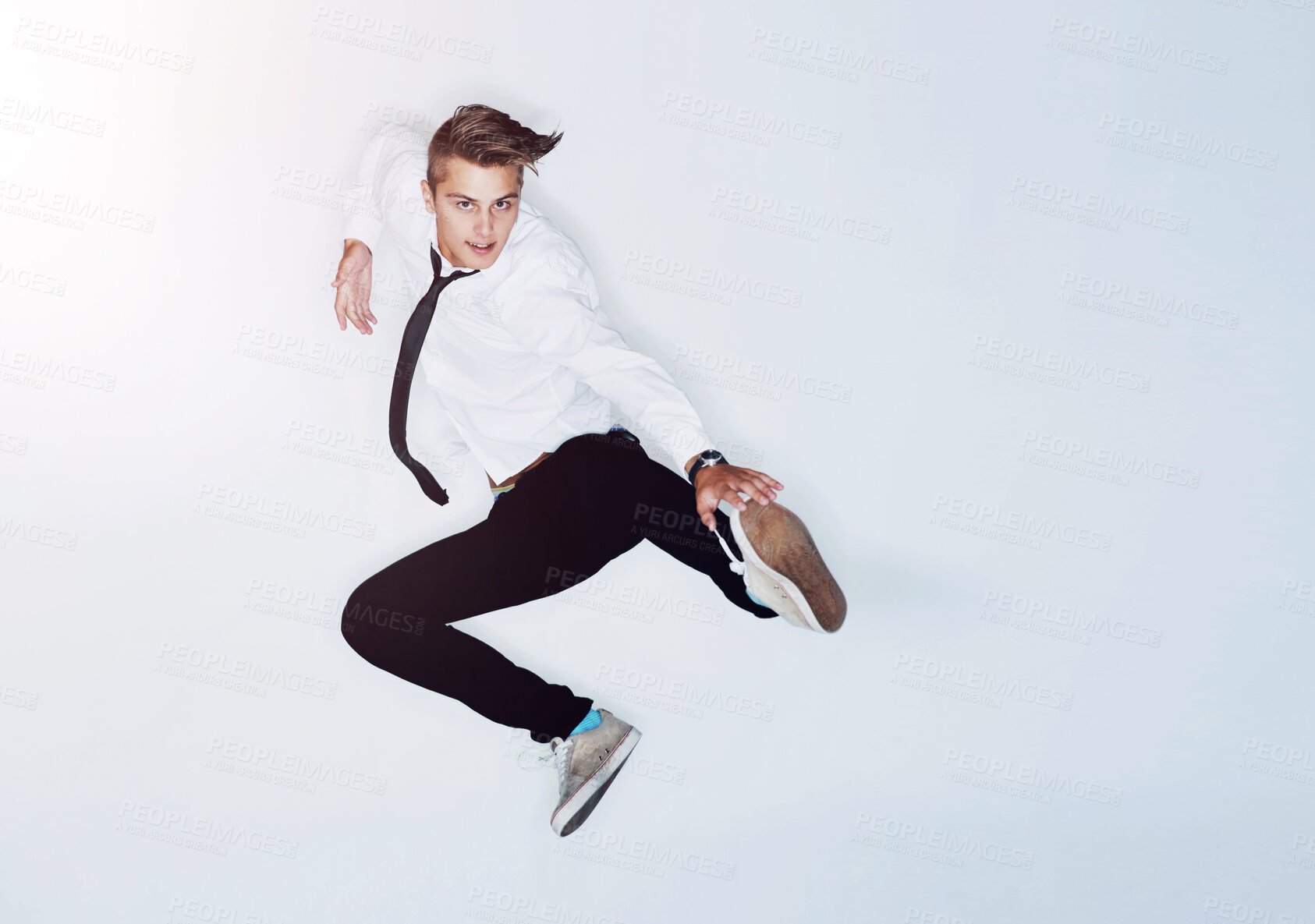 Buy stock photo Portrait of a trendy young man in mid-air against a white background