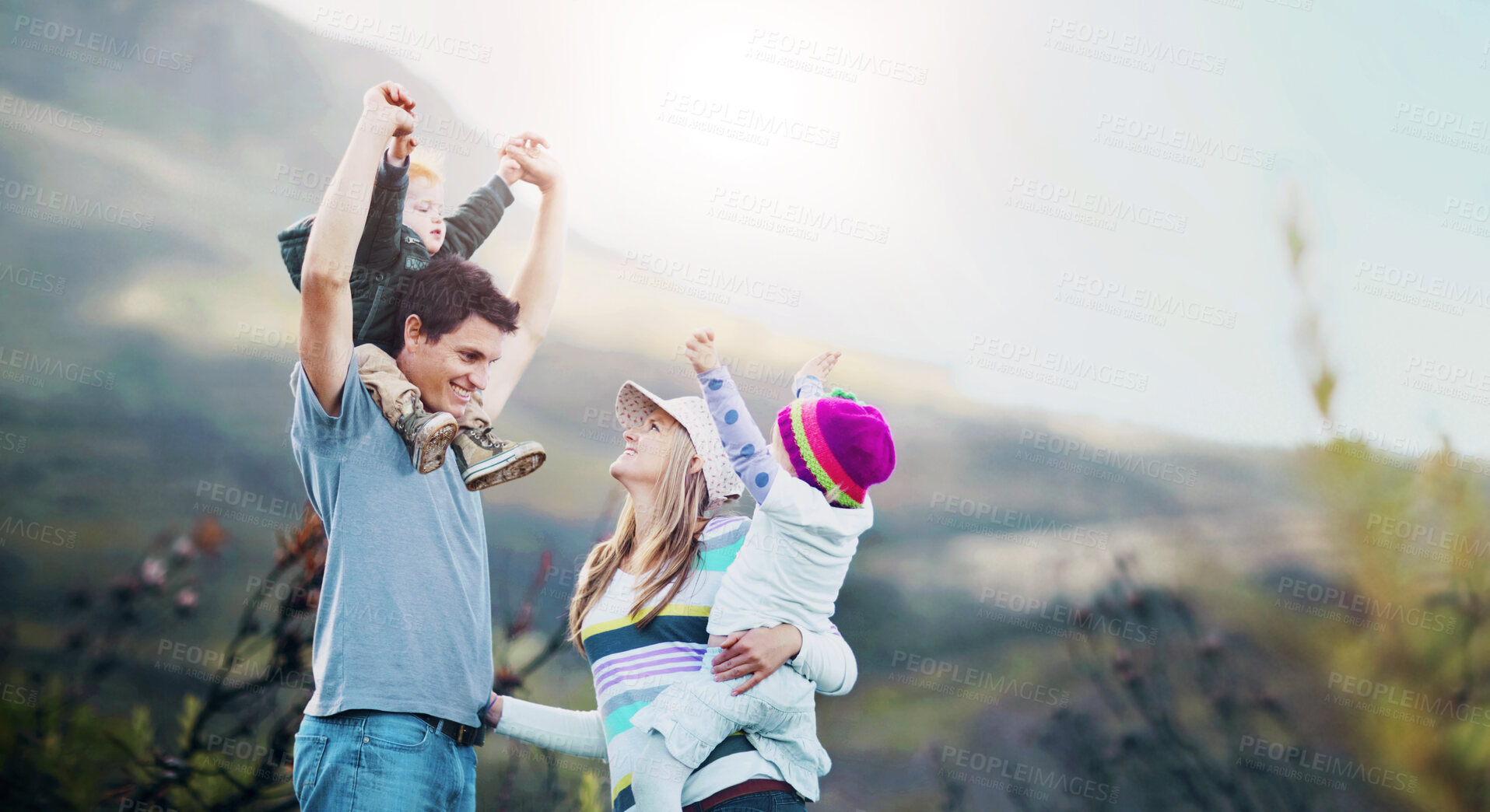 Buy stock photo A young family with the children on their parent's shoulders while out hiking together