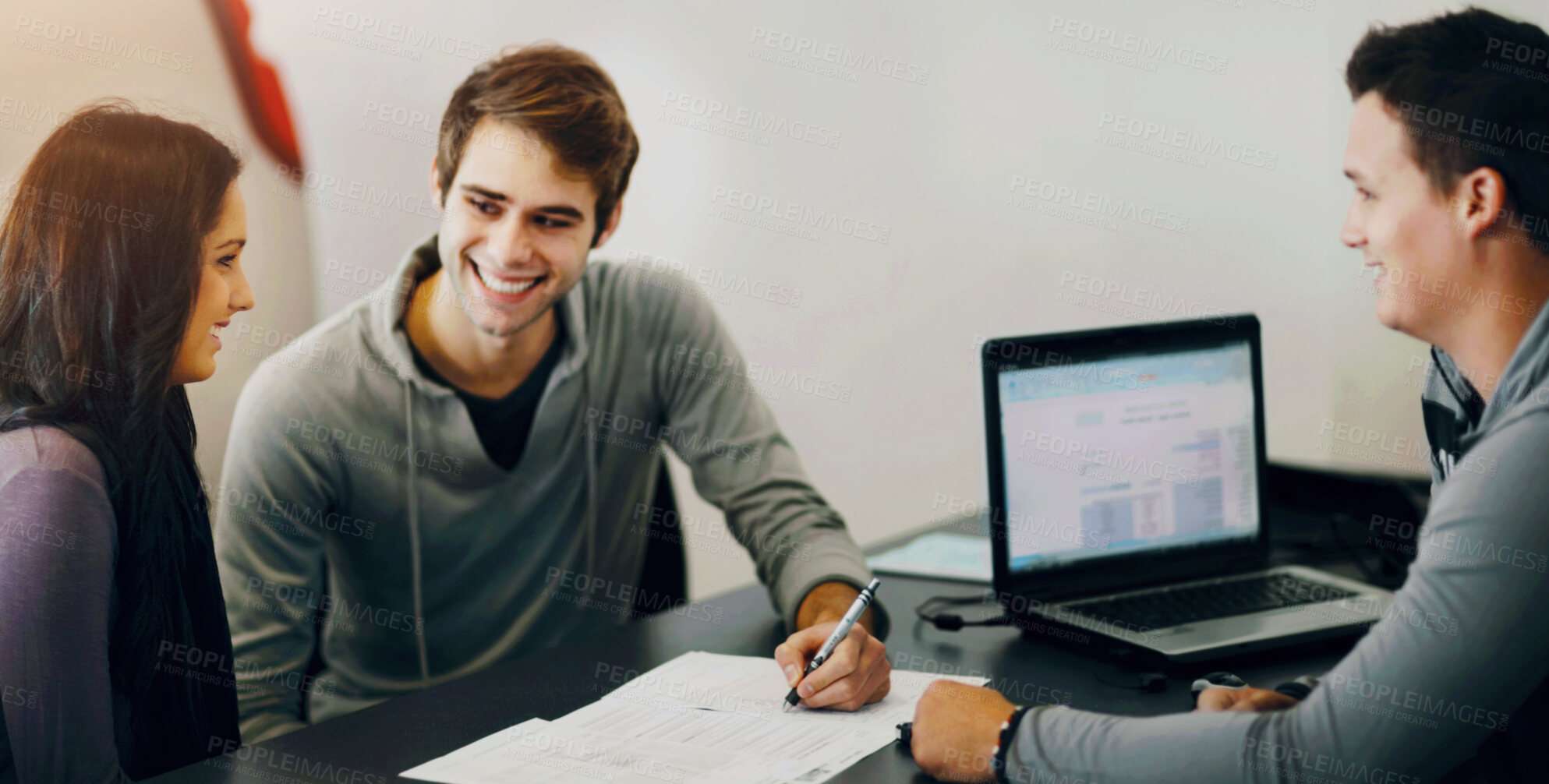 Buy stock photo Shot of a young couple filling out paperwork with an advisor